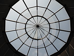 Glass dome or round window in the roof. The sky can be seen through a glass transparent structure in the vault of the
