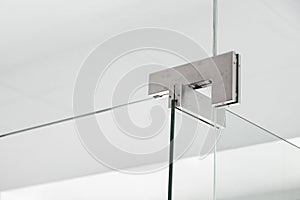 Glass door hinges to bathroom, close up.