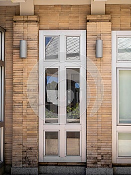 Glass  doors with turquoise frames at red bricked