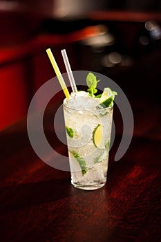 Glass with drinks and alcohol and citrus in bar table 