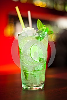 Glass with drinks and alcohol and citrus in bar table 