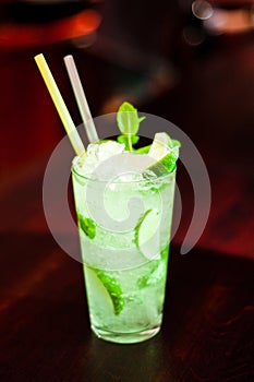 Glass with drinks and alcohol and citrus in bar table 