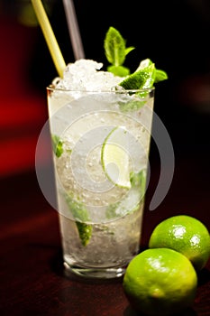 Glass with drinks and alcohol and citrus in bar table 