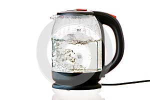 Glass electric kettle with boiling water on a white insulated background