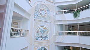 Glass elevator moving down inside luxury hotel. Glass elevator hotel moving down