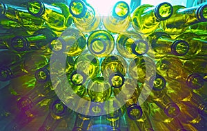 Glass empty beer bottles lie in rows, open the necks on the camera