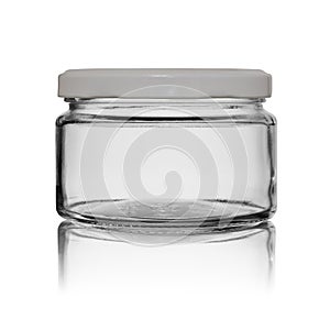 Glass empty jar for food canned closed by a white metal cover with reflection. Isolated on a white background