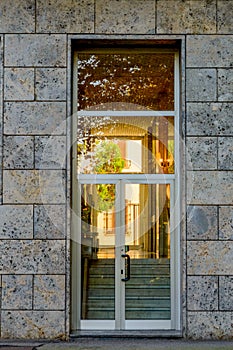 The glass entrance door to the building. Modern Architecture of Building Entrance