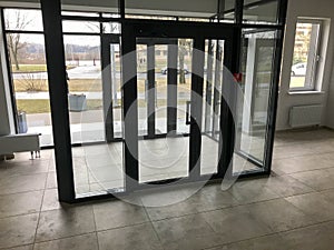 The glass entrance at the entrance to the building store office with sliding double doors