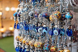 The glass evil eye keychains for sale in the souvenir shop photo