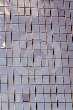 Glass facade background with blue sky reflection. Modern architecture and structure. Construction and design. Commercial