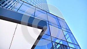 Glass facade of the buildings with a blue sky. Skyscrapers in the business city center.