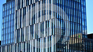 Glass facade of the buildings with a blue sky. Skyscrapers in the business city center.