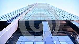 Glass facade of the buildings with a blue sky. Skyscrapers in the business city center.