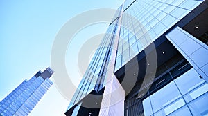 Glass facade of the buildings with a blue sky. Skyscrapers in the business city center.