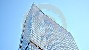 Glass facade of the buildings with a blue sky. Skyscrapers in the business city center.