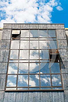 Glass facade with clouds reflections