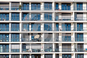 Glass facade of a modern apartment building with a lot of balconies