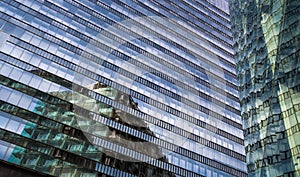 Glass Facade Of Modern Office Buildings With Reflections Of Neighboring Towers In The City Of Vienna