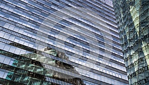 Glass Facade Of Modern Office Buildings With Reflections Of Neighboring Towers In The City Of Vienna