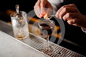 Glass filled with the dark alcoholic drink with a smoky note