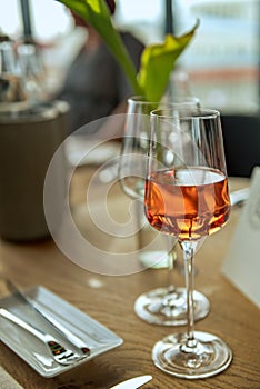 A glass filled with rose wine