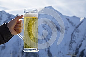 A glass filled with sparkling beer with a foam collar