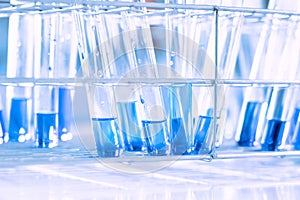 Glass flask in chemical science education laboratory with molecular structure in blue background