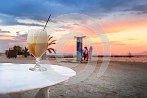 A freddo cappuccino cold coffee at the beach at sunset in Volos, Greece. photo