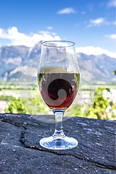 A glass of fresh beer on the background of the mountains