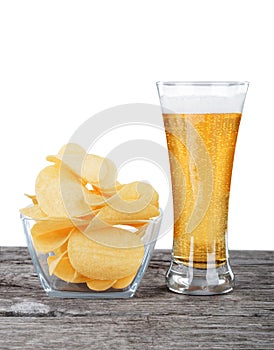 Glass of Fresh Beer and bowl of with Pile potato chips