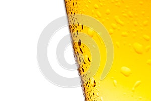 Glass of fresh beer with drops on white background