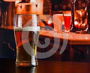 Glass of fresh beer on wood table