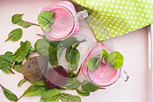 Glass of fresh beetroot juice with bets and leafs . Beetroot smoothie in jar. Pink detox. Eye bird view.