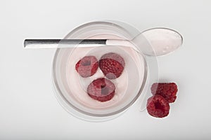 Glass of fresh berries and yogurt on white background