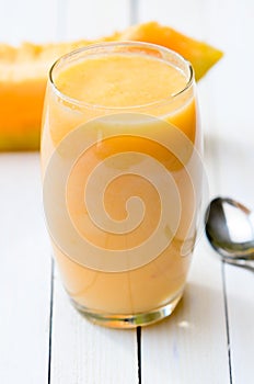 Glass of fresh cantaloupe smoothie