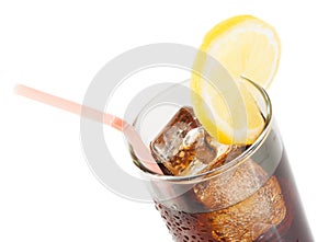 Glass of fresh coke with straw with lemon slice on top, summer time