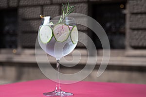 Glass of fresh cold water with ice and cucumber slices