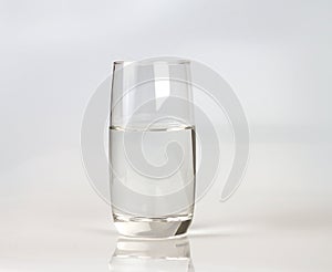 Glass of fresh drink water on grey backgrund photo