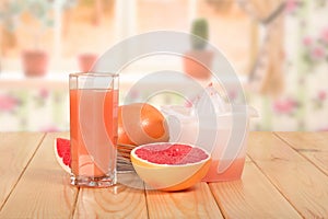 A glass of fresh grapefruit juice, half grapefruit, piece, whole