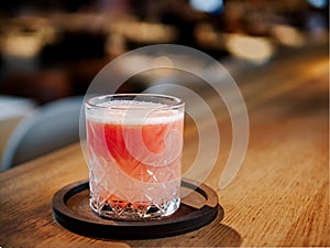 Glass of fresh grapefruit juice in restaurant interior