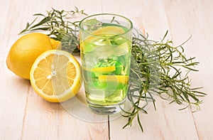 Glass of fresh homemade lemonade with tarragon and lemon