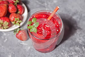 Glass with fresh homemade strawberry sweet iced tea or cocktail, lemonade with mint. Refreshing cold drink. Summer party