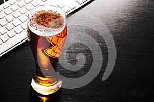 Glass of lager beer on table photo