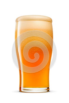 Glass of fresh orange-colored beer with cap of foam isolated on white background. Fruit beer cocktail overflowing