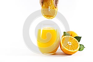 Glass of fresh orange juice with fruits cut in half and sliced with green leaf isolated on white background, clipping path