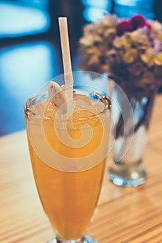 Glass of fresh orange juice with ice. Cafe. Bali island, Indonesia.