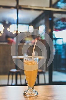 Glass of fresh orange juice with ice. Cafe. Bali island, Indonesia.