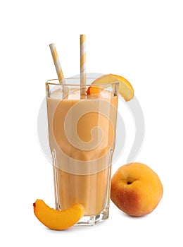 Glass with fresh peach smoothie on white background