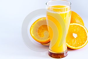 Glass with fresh squeezed orange juice and oranges on white healthy life concept